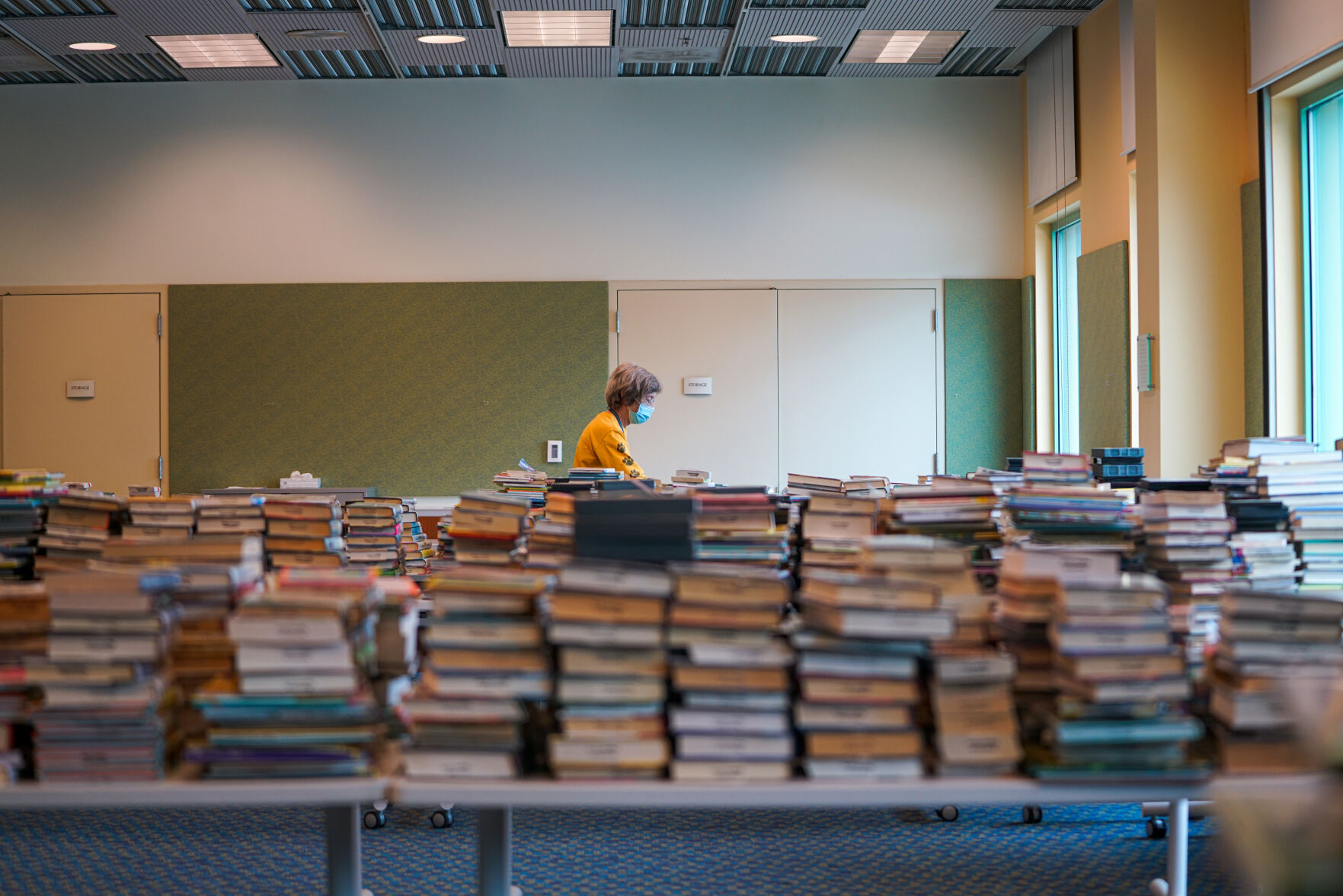 Jodie Lenser organizes books returned by readers